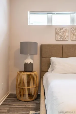 a bedroom with a bed and wall painting