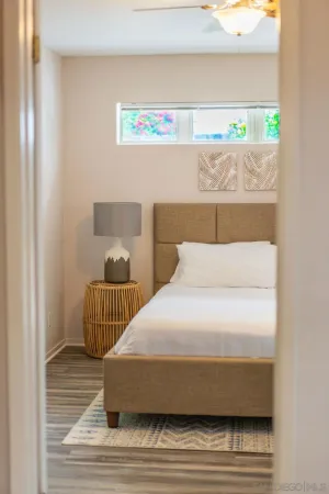 a bedroom with a bed and a window