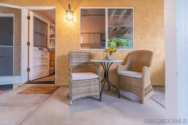 a outdoor living room with furniture and a window