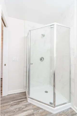 a bathroom with a glass shower door