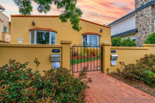 a front view of a house with a garden