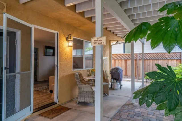 a view of a patio with table and chairs and potted plants