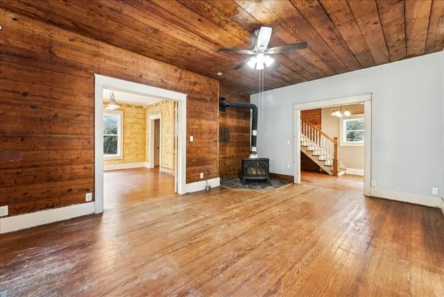 a view of a livingroom with wooden floor and a ceiling fan