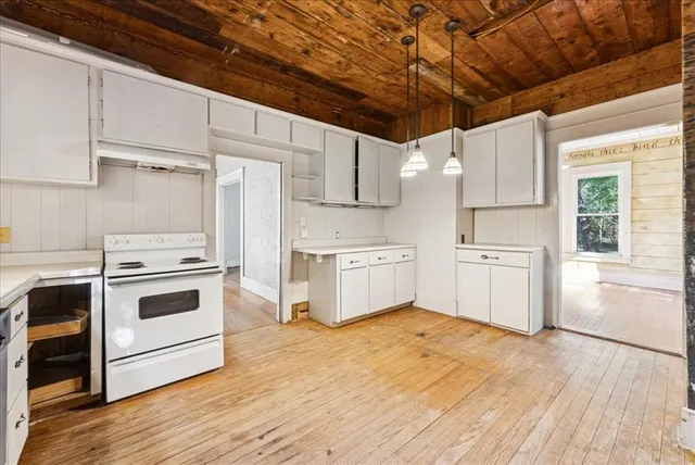 a kitchen with a white cabinets and white appliances