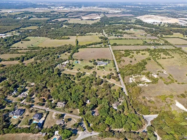 an aerial view of ocean with residential houses and lake view