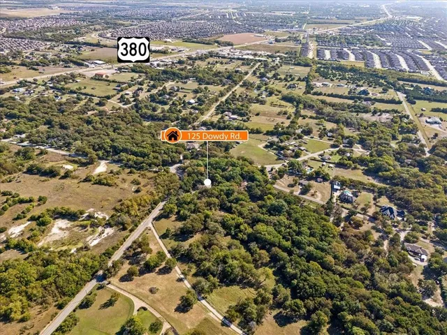an aerial view of residential houses with yard