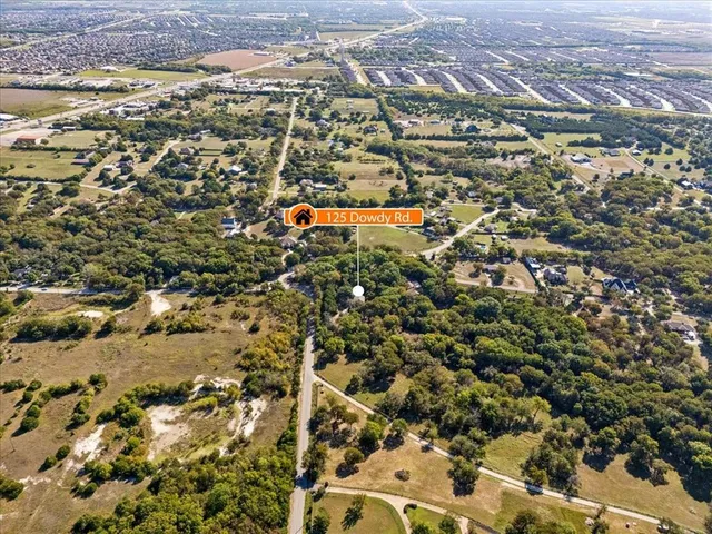 an aerial view of residential houses with city view