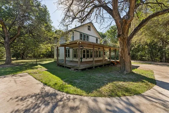 a front view of a house with a yard table and chairs