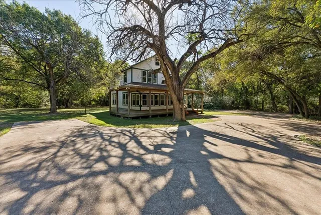 a view of street with large trees