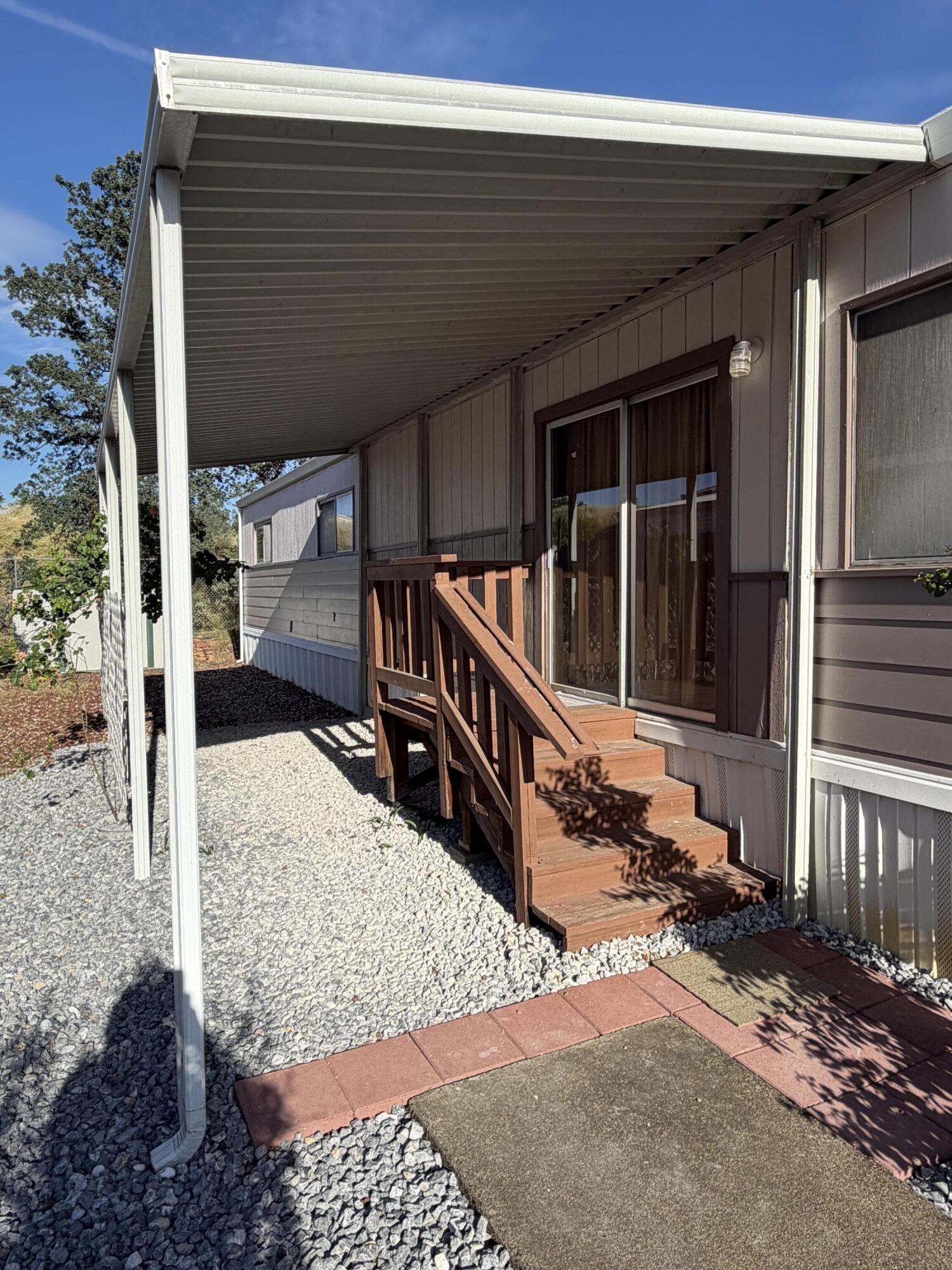 1449 Menomenee Lane, Unit 252 Redding, CA 96003 - Photo 2 of 18 a view of balcony with a potted plant