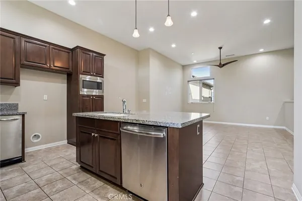 a kitchen with kitchen island a sink stainless steel appliances and cabinets