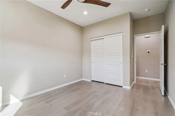 an empty room with wooden floor and closet