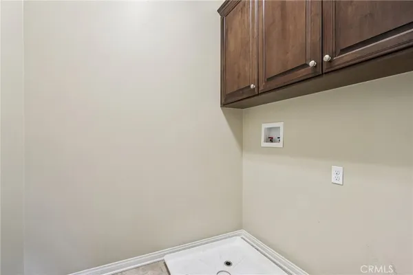 a small space with wooden floor and cabinets