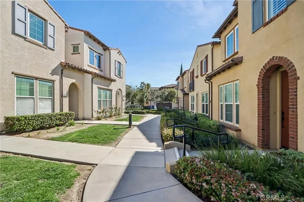 a view of a brick building next to a yard