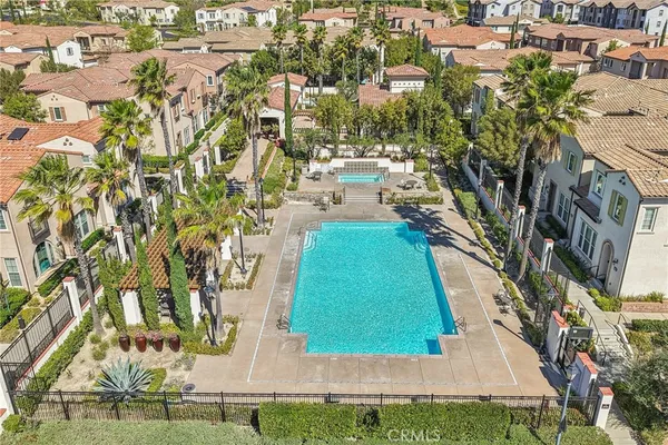 an aerial view of residential houses with outdoor space and street view