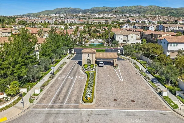 an aerial view of residential houses with outdoor space and ocean view