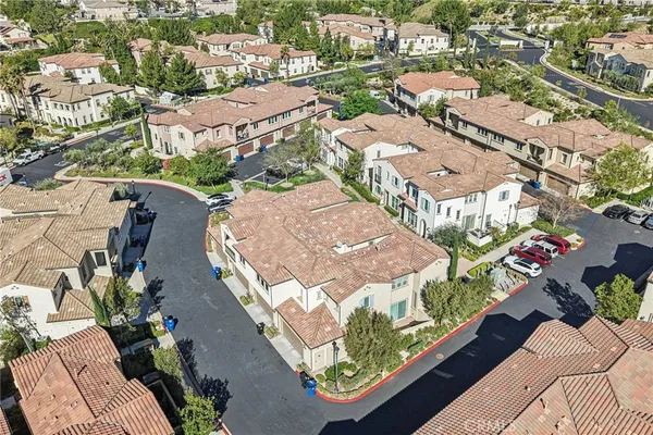 an aerial view of residential houses with outdoor space and street view
