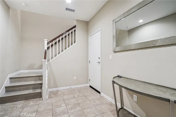 a view of entryway with stairs and a rug