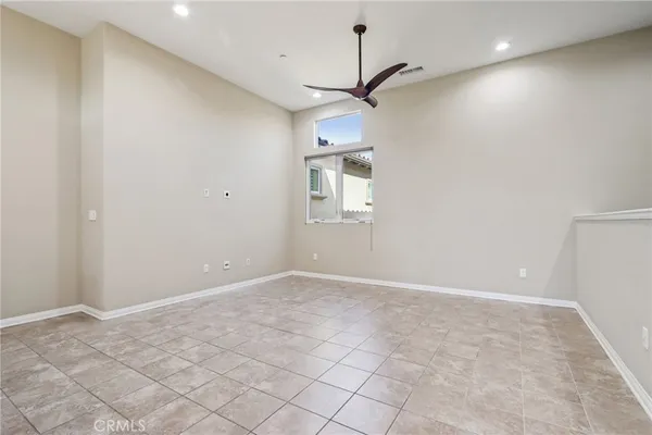 an empty room with a empty space and windows