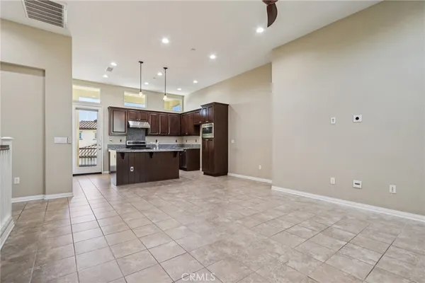 a open kitchen with cabinets and stainless steel appliances