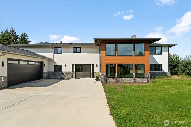 a front view of a house with a yard and garage