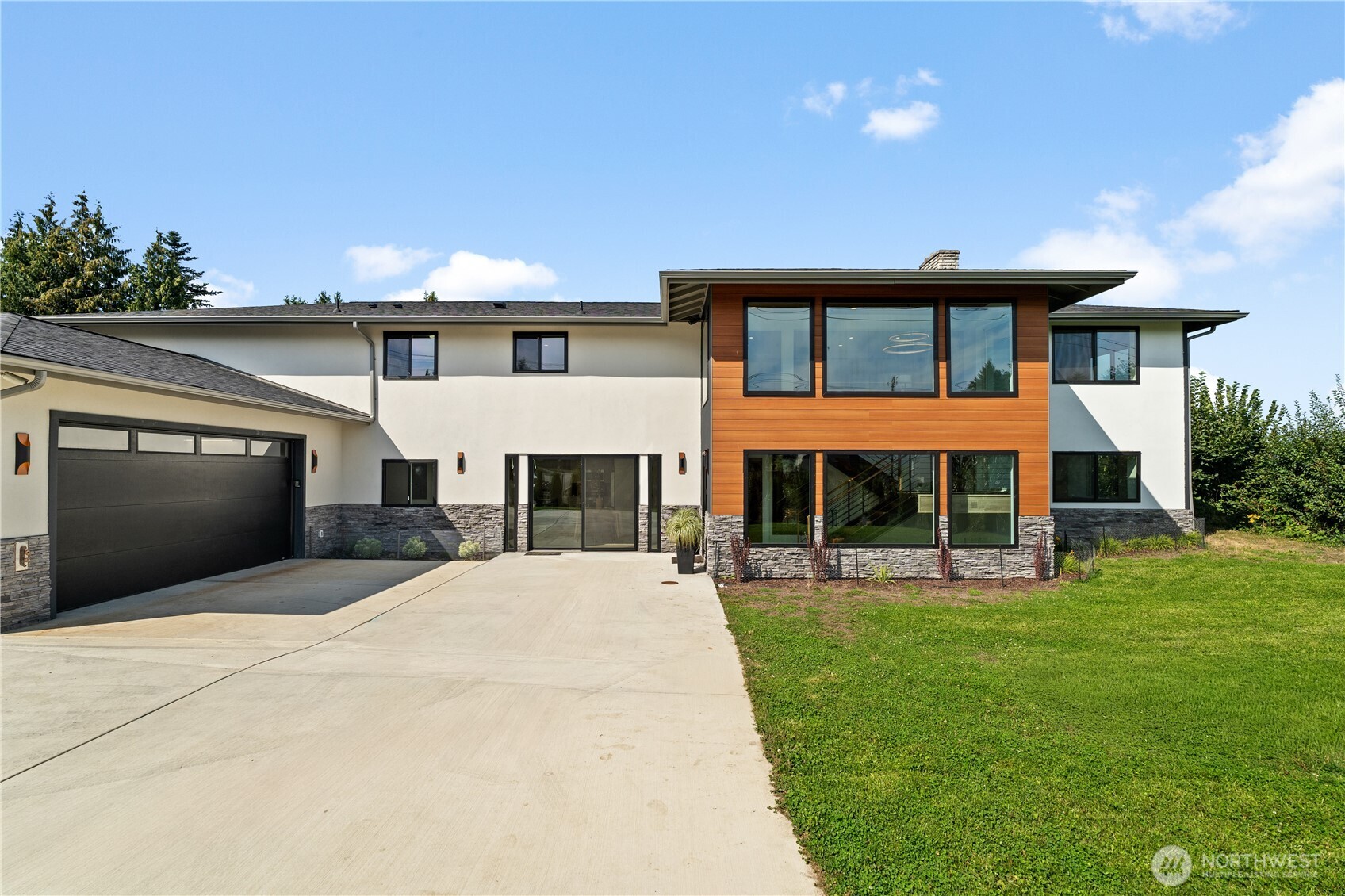 a front view of a house with a yard and garage