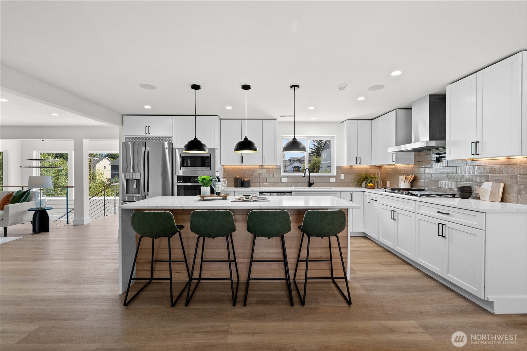 12208 Southeast 192nd Street Renton, WA 98058 - Photo 12 of 40 a kitchen with stainless steel appliances kitchen island granite countertop a table chairs sink and cabinets