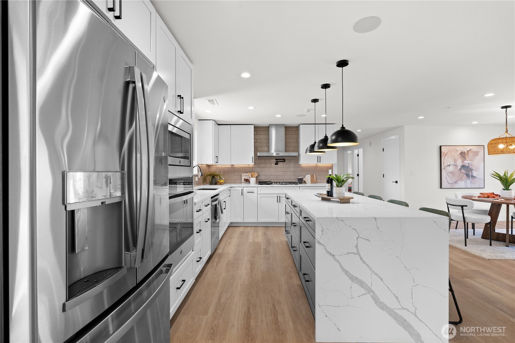 12208 Southeast 192nd Street Renton, WA 98058 - Photo 13 of 40 a large kitchen with stainless steel appliances lots of counter space and a refrigerator