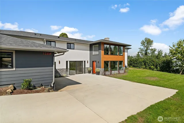 a front view of a house with a yard and garage