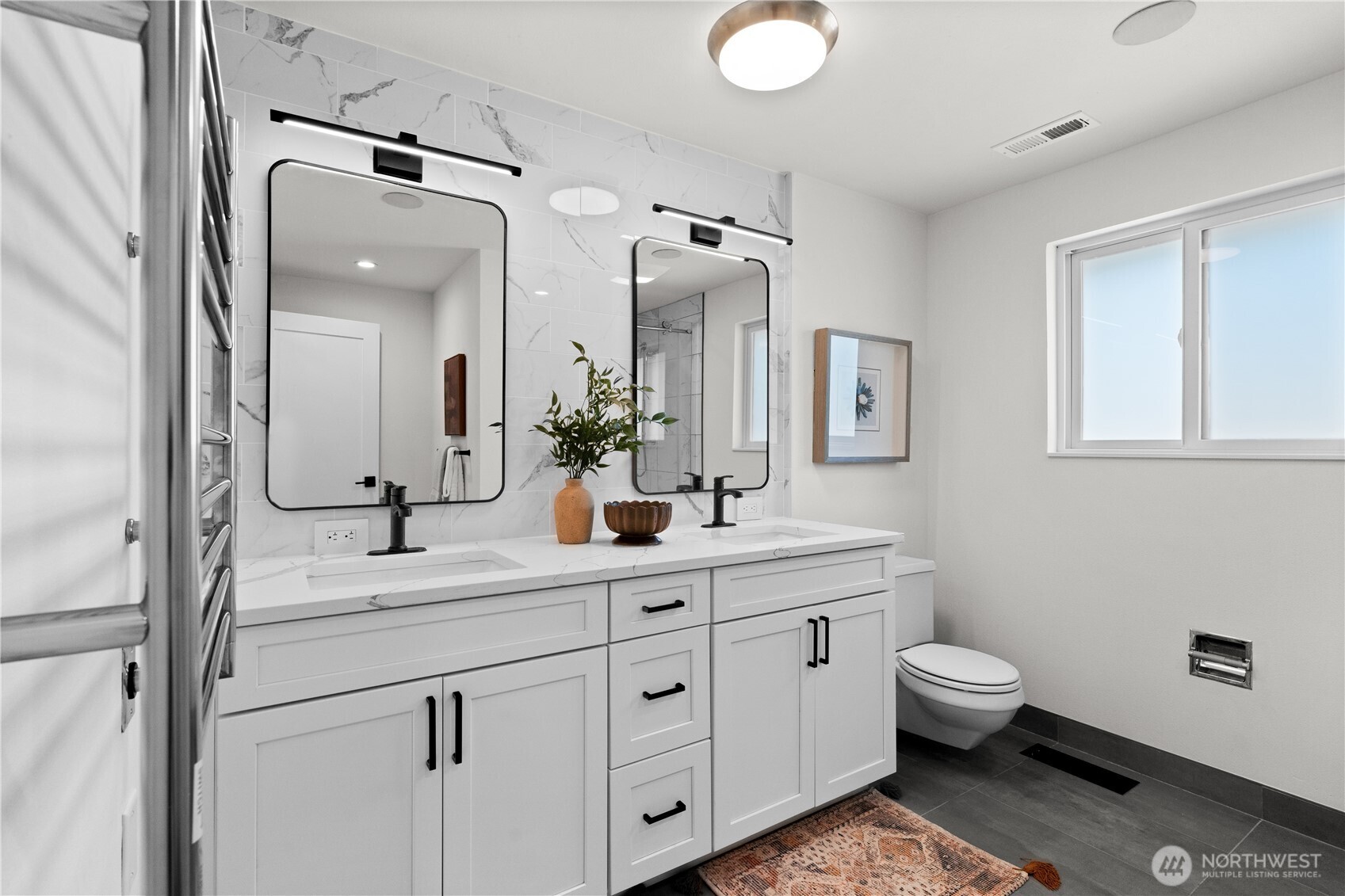 12208 Southeast 192nd Street Renton, WA 98058 - Photo 23 of 40 a bathroom with a double vanity sink toilet mirror and window