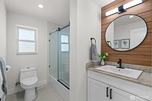 a living room with furniture a rug and a potted plant