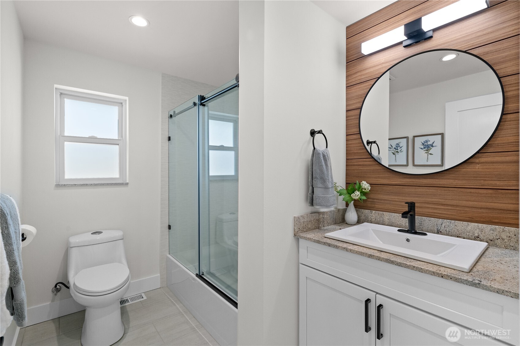 12208 Southeast 192nd Street Renton, WA 98058 - Photo 25 of 40 a bathroom with a toilet a sink and mirror