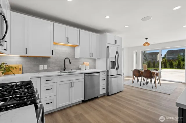 a view of a dining room with furniture and chandelier