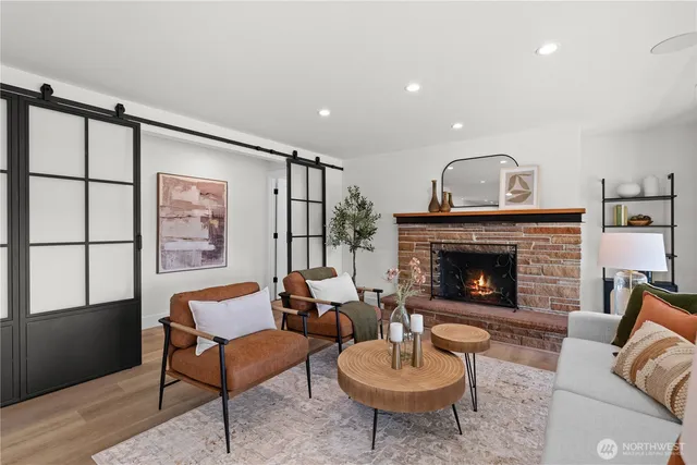 a kitchen with stainless steel appliances granite countertop a sink a stove a refrigerator and island with wooden floor