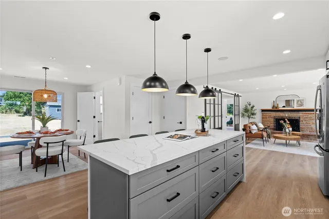 a kitchen with a sink a stove cabinets and wooden floor