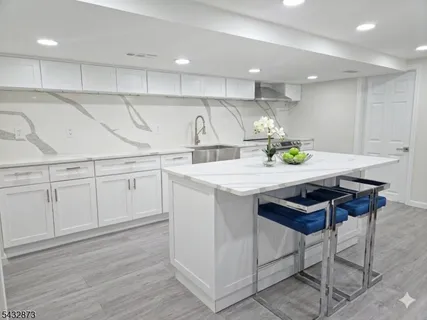 a kitchen with a sink cabinets and wooden floor