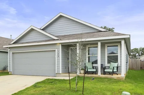 a front view of house with a garden and plants
