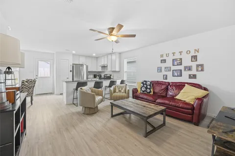 a living room with furniture and kitchen view
