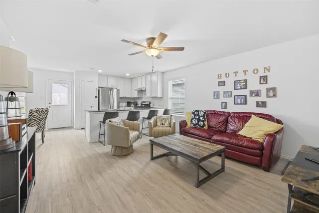 a living room with furniture and kitchen view