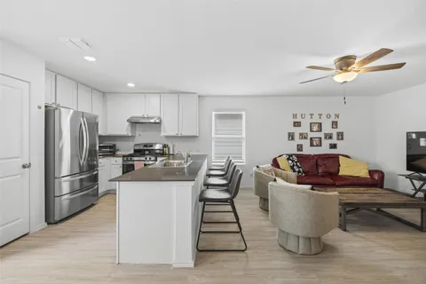 a kitchen with a refrigerator and a sink