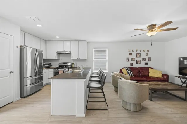 a kitchen with a refrigerator and a sink