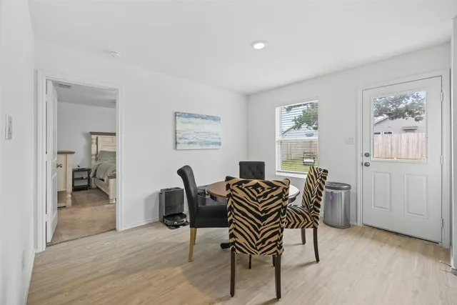 a dining room with furniture and window