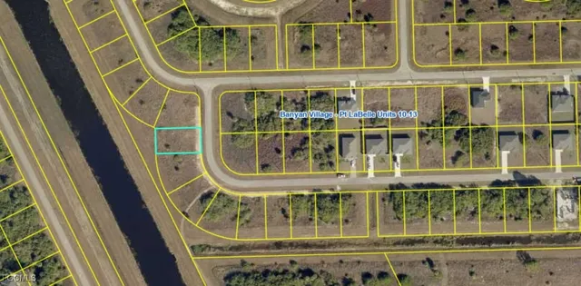 a view of a lake with houses in the back