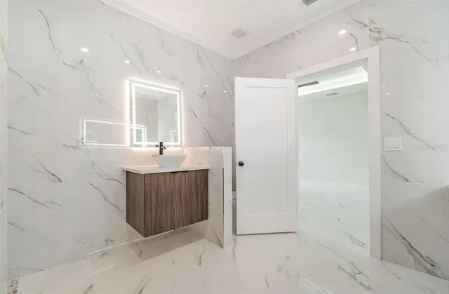 a bathroom with a sink shower and a mirror