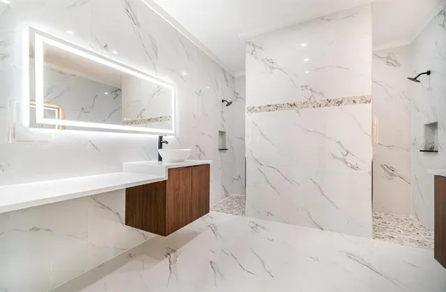 a bathroom with a bathtub sink and mirror
