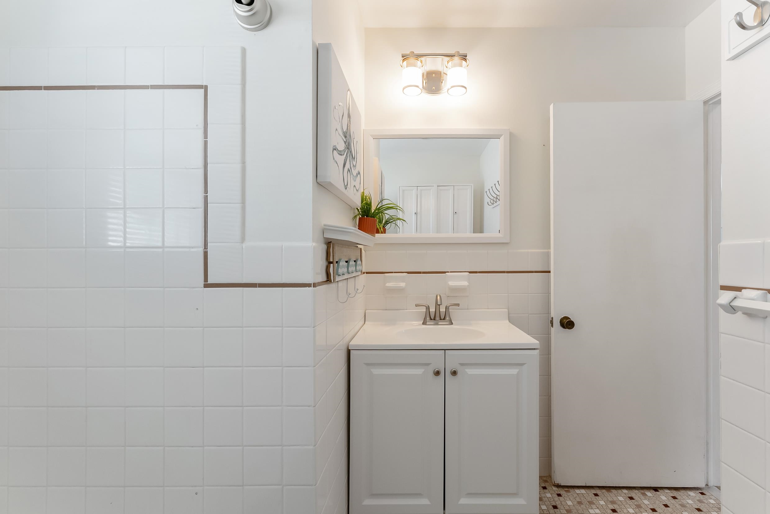 647 Barry Road Avalon, NJ 08202 - Photo 20 of 25 a bathroom with a sink and a mirror
