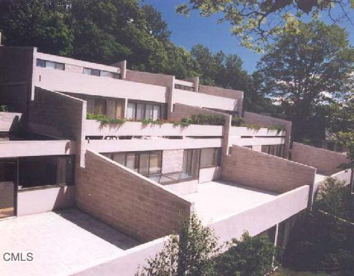 9 Riversville Road, Unit 15 Greenwich, CT 06831 - Photo 1 of 1 a view of a house with roof deck and seating space