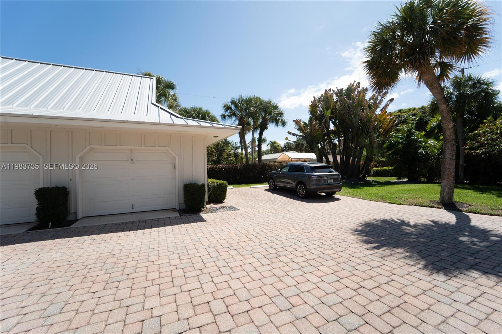 851 Saturn Street, Unit D Jupiter, FL 33477 - Photo 45 of 60 a view of a parking space with potted plants