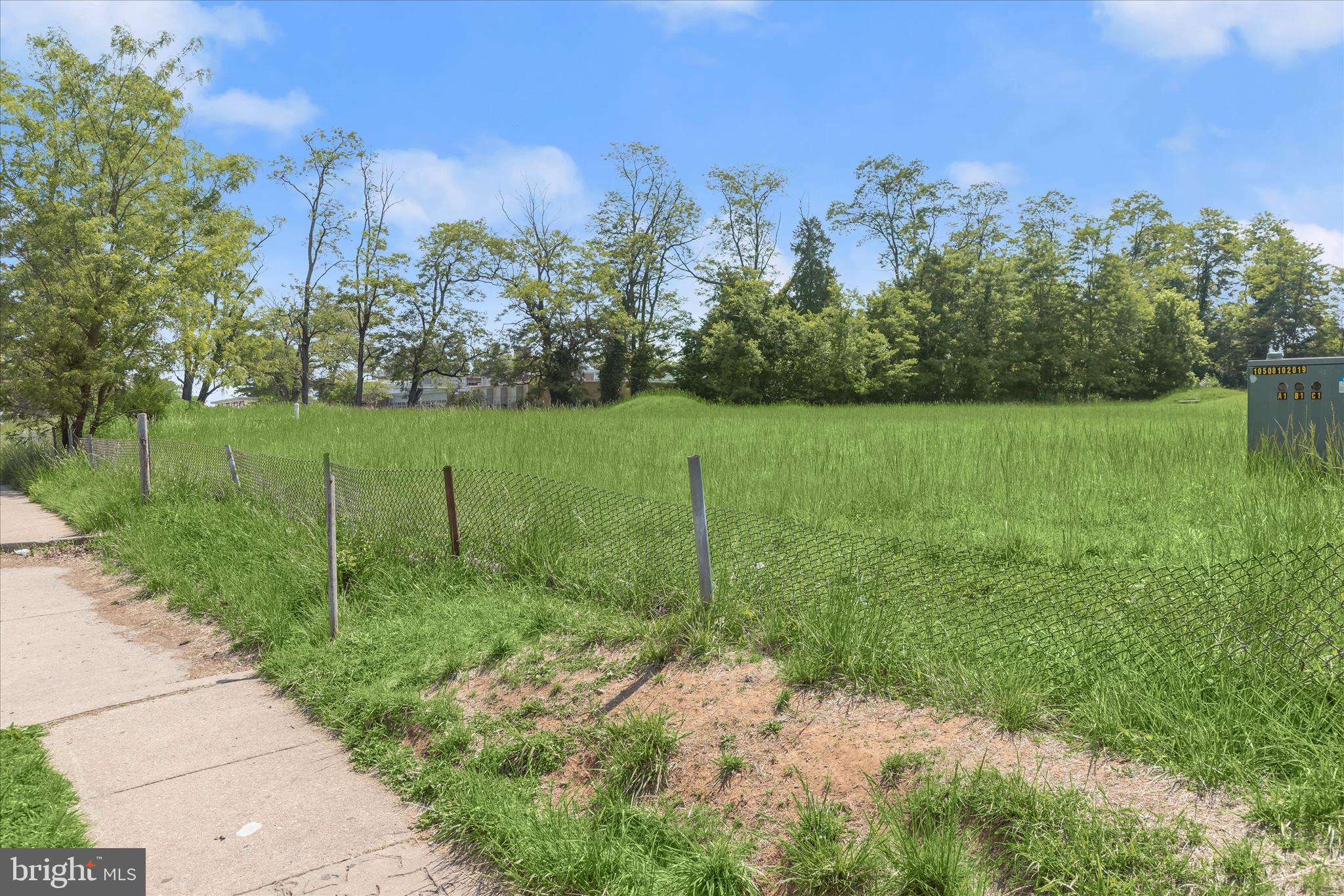 3925 Rolling Rd. Baltimore, MD 21208 - Photo 19 of 27 a view of a grassy field with trees