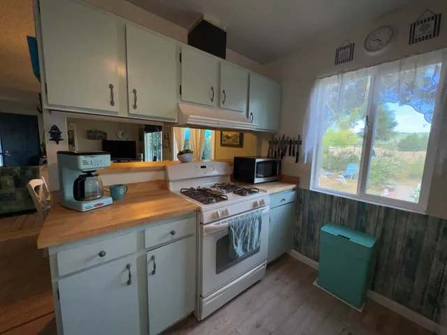 a kitchen with stainless steel appliances granite countertop a stove and a refrigerator